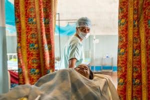 A fistula patient is wheeled into the ward on a hospital bed
