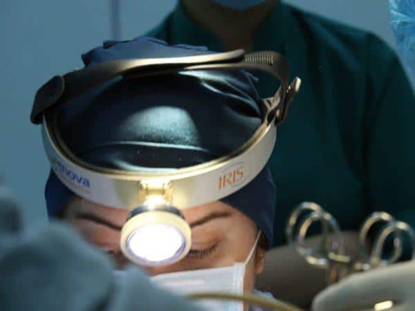 Surgeon performing fistula repair surgery